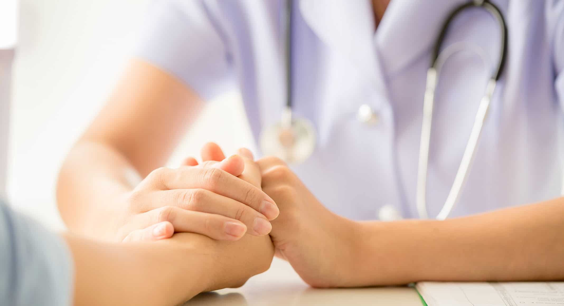 female psychologist consulting patient at the desk in hospital.