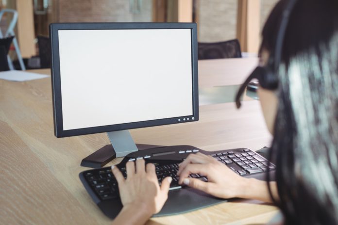 Cropped image of businesswoman working on computer at call center