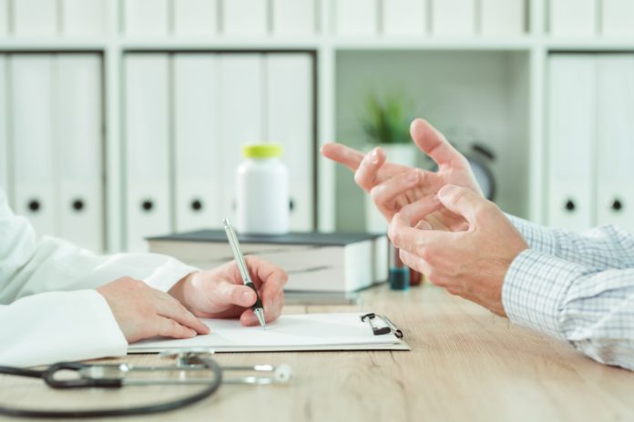 Doctor and patient during consultation in medical office Doctor and patient during consultation in medical office