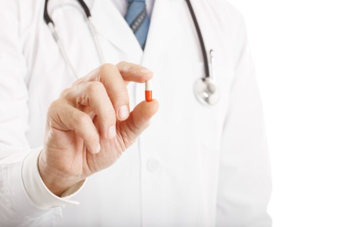 Doctor holding a pill Doctor holding a pill
