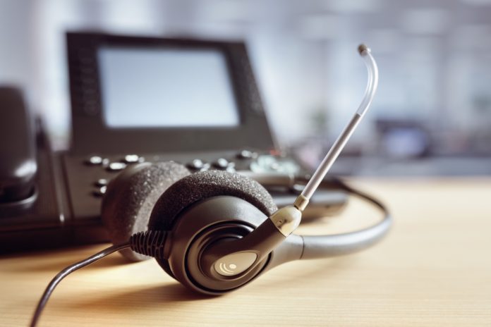Headset headphones and telephone in call center Headset headphones and telephone in call center