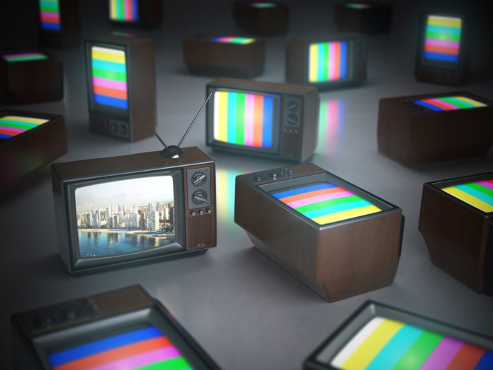 Pile of vintage TV with one in standby. TV channels concept