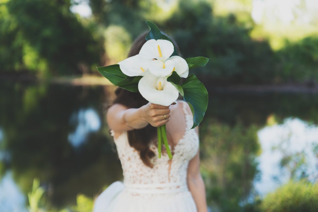 Young beautiful bride holding a bouquet.